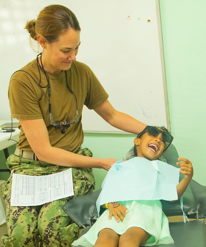 A dentist treats a patient.