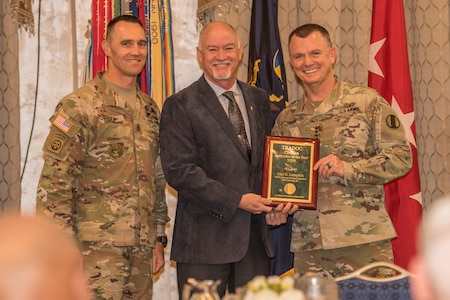 Gen. Paul E. Funk II, commanding general, U.S. Army Training and Doctrine Command, and TRADOC Command Sgt. Maj. Timothy A. Guden, pose for a photo with Carl Lumpkin, the 2019 Civilian Instructor of the Year during the TRADOC Instructor of the Year Awards Ceremony at Fort Eustis, Va., Aug. 7, 2019. The seven awardees were recognized at a ceremony during the TRADOC Commander's Forum.  (U.S. Army photo by Gwyndolynn Giacomo)