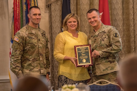 Gen. Paul E. Funk II, commanding general, U.S. Army Training and Doctrine Command, and TRADOC Command Sgt. Maj. Timothy A. Guden, pose for a photo with Loretta Harris, the 2019 Army National Guard Instructor of the Year during the TRADOC Instructor of the Year Awards Ceremony at Fort Eustis, Va., Aug. 7, 2019. The seven awardees were recognized at a ceremony during the TRADOC Commander's Forum.  (U.S. Army photo by Gwyndolynn Giacomo)
