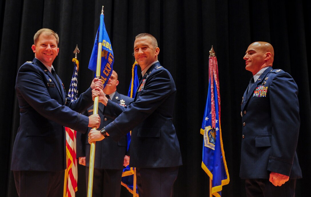 Col. Duane J. Diesing accepts command of the National Air and Space Intelligence Center’s Global Exploitation Intelligence Group from Col. Parker H. Wright, NASIC commander, July 27. GX is responsible for executing analysis of signals intelligence, human intelligence, open source intelligence, and foreign materiel exploitation to create integrated intelligence for NASIC and the nation. (Air Force photo by Senior Airman Michael J. Hunsaker)