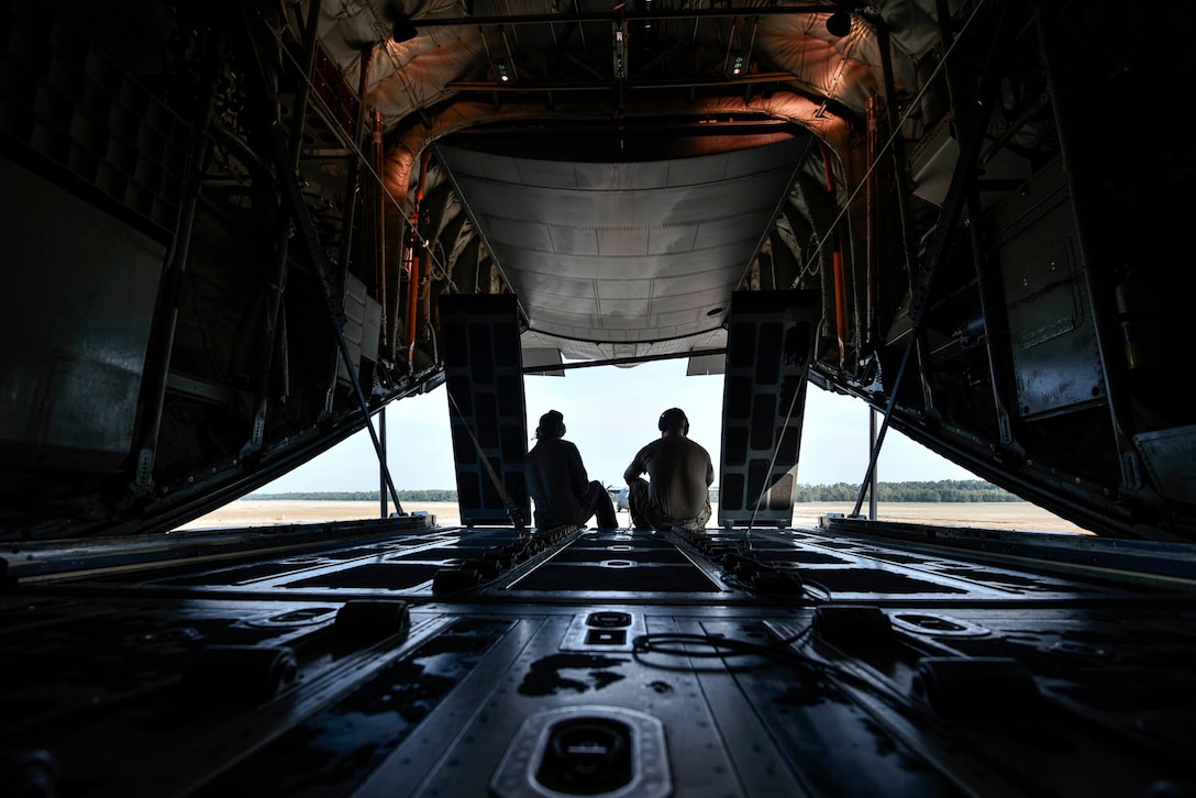Tech. Sgt. William Mcleod, 327th Airlift Squadron loadmaster, and Staff Sgt. Anthony Miller, 327th Airlift Squadron loadmaster, discuss the plan for the ongoing exercise as the C-130J taxis down the runway during the Turkey Shoot competition August 7, 2019, at Little Rock Air Force Base, Ark. The majority of our Reserve members must meet the same requirements of Active Duty personnel. This requires balancing a fulltime civilian job or college studies while maintaining their military readiness. Mission success depends on Airmen resiliency and their ability to overcome adversity. (U.S. Air Force Reserve photo by Senior Airman Nathan Byrnes)