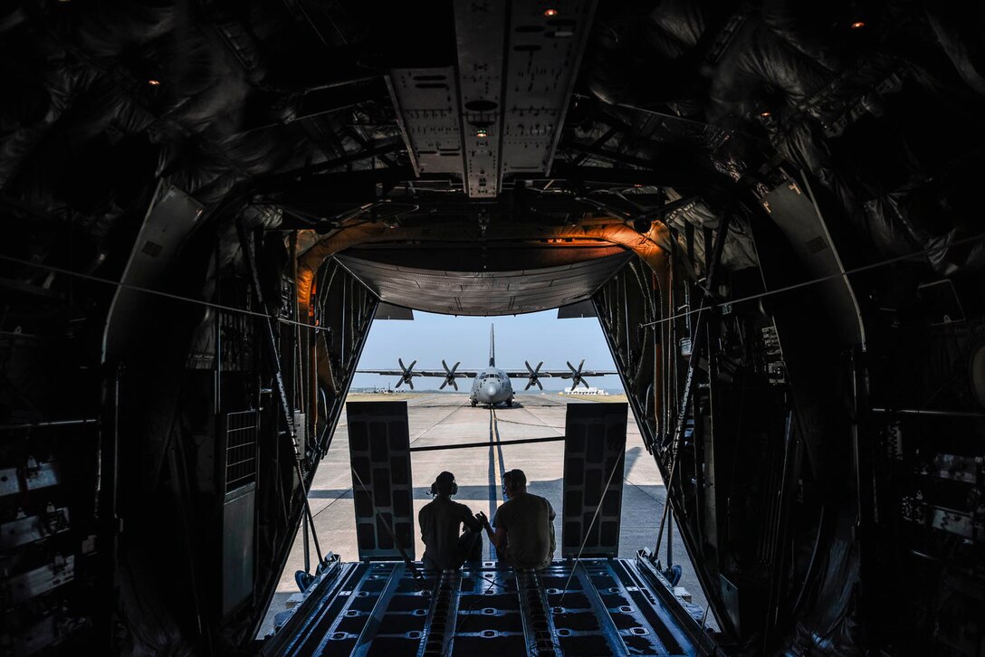 Tech. Sgt. William Mcleod, 327th Airlift Squadron loadmaster, and Staff Sgt. Anthony Miller, 327th Airlift Squadron loadmaster, discuss the plan for the ongoing exercise as the C-130J taxis down the runway during the Turkey Shoot competition August 7, 2019, at Little Rock Air Force Base, Ark. The majority of our Reserve members must meet the same requirements of Active Duty personnel. This requires balancing a fulltime civilian job or college studies while maintaining their military readiness. Mission success depends on Airmen resiliency and their ability to overcome adversity. (U.S. Air Force Reserve photo by Senior Airman Nathan Byrnes)