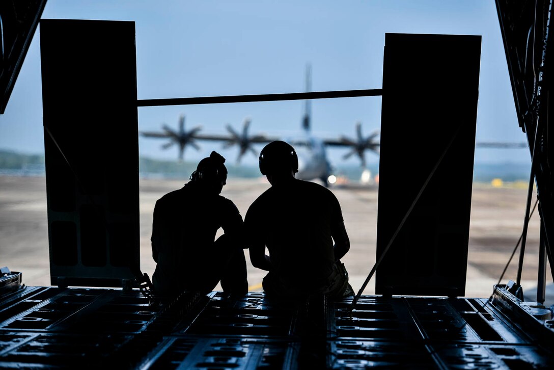 Tech. Sgt. William Mcleod, 327th Airlift Squadron loadmaster, and Staff Sgt. Anthony Miller, 327th Airlift Squadron loadmaster, discuss the plan for the ongoing exercise as the C-130J taxis down the runway during the Turkey Shoot competition August 7, 2019, at Little Rock Air Force Base, Ark. The majority of our Reserve members must meet the same requirements of Active Duty personnel. This requires balancing a fulltime civilian job or college studies while maintaining their military readiness. Mission success depends on Airmen resiliency and their ability to overcome adversity. (U.S. Air Force Reserve photo by Senior Airman Nathan Byrnes)