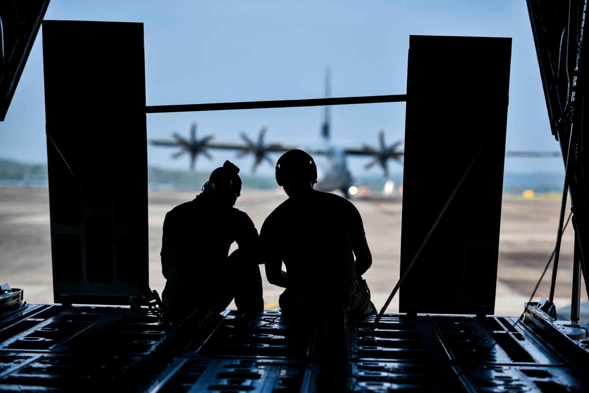 Tech. Sgt. William Mcleod, 327th Airlift Squadron loadmaster, and Staff Sgt. Anthony Miller, 327th Airlift Squadron loadmaster, discuss the plan for the ongoing exercise as the C-130J taxis down the runway during the Turkey Shoot competition August 7, 2019, at Little Rock Air Force Base, Ark. The majority of our Reserve members must meet the same requirements of Active Duty personnel. This requires balancing a fulltime civilian job or college studies while maintaining their military readiness. Mission success depends on Airmen resiliency and their ability to overcome adversity. (U.S. Air Force Reserve photo by Senior Airman Nathan Byrnes)