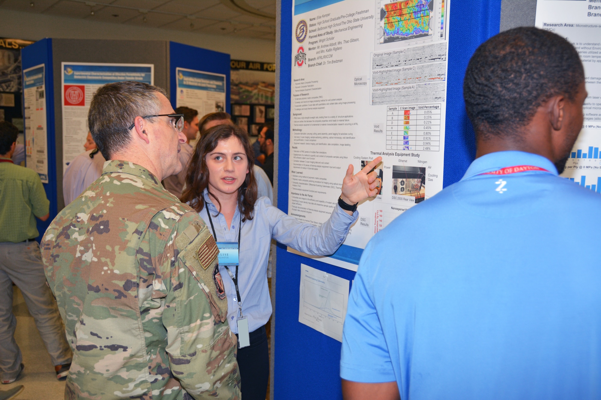Elise Kemper, a 2019 Belbrook High School graduate, presents her research poster to Maj. Gen. William T. Cooley, commander of the Air Force Research Laboratory, at the summer student research poster session Aug. 1. Kemper’s research area this summer was Polymeric Matrix Composites. She will be attending Ohio State University this fall, studying mechanical engineering. (U.S. Air Force photo/Spencer Deer)
