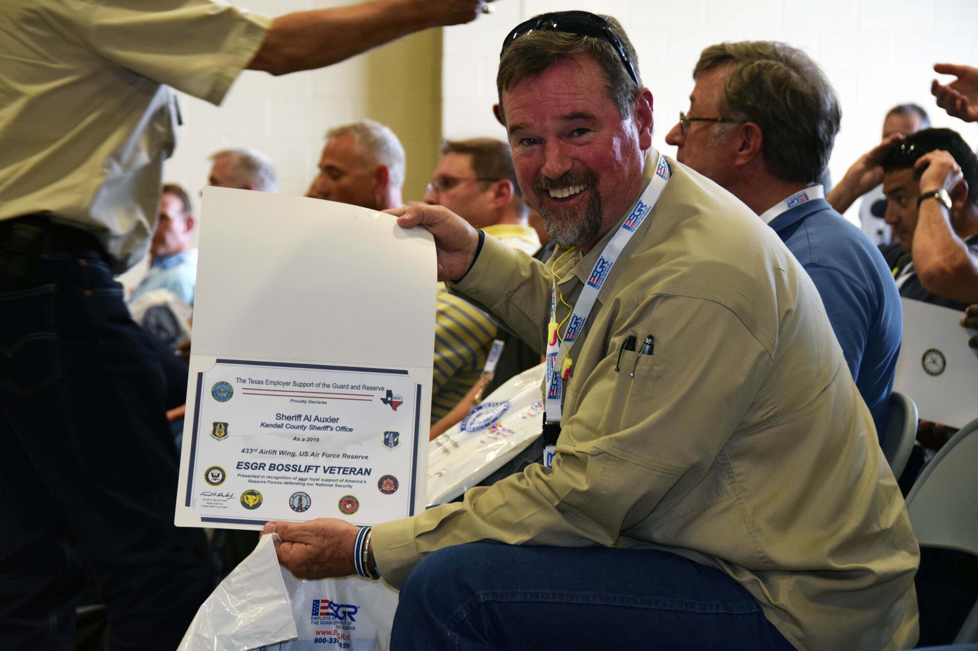 Kendall County Sheriff Al Auxier shows-off a certificate presented to him after completing the Employer Support of Guard and Reserve Bosslift event at Joint Base San Antonio-Lackland, Texas Aug. 3, 2019.