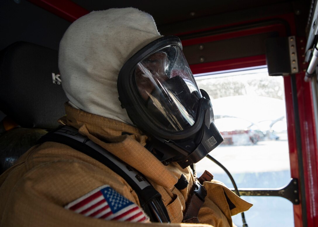 Airman 1st Class Lakeem Coleman, 23d Civil Engineer Squadron (CES) firefighter, rides in a fire truck in response to an A-10C Thunderbolt II egress training scenario, Aug. 9, 2019, at Moody Air Force Base, Ga. The 23d CES conducted the exercise to test their capability in extinguishing an A-10 on fire while simultaneously rescuing its pilot. The training also served as an opportunity for firefighter crew chiefs and their Airmen to increase team cohesion. (U.S. Air Force photo by Airman Azaria E. Foster)