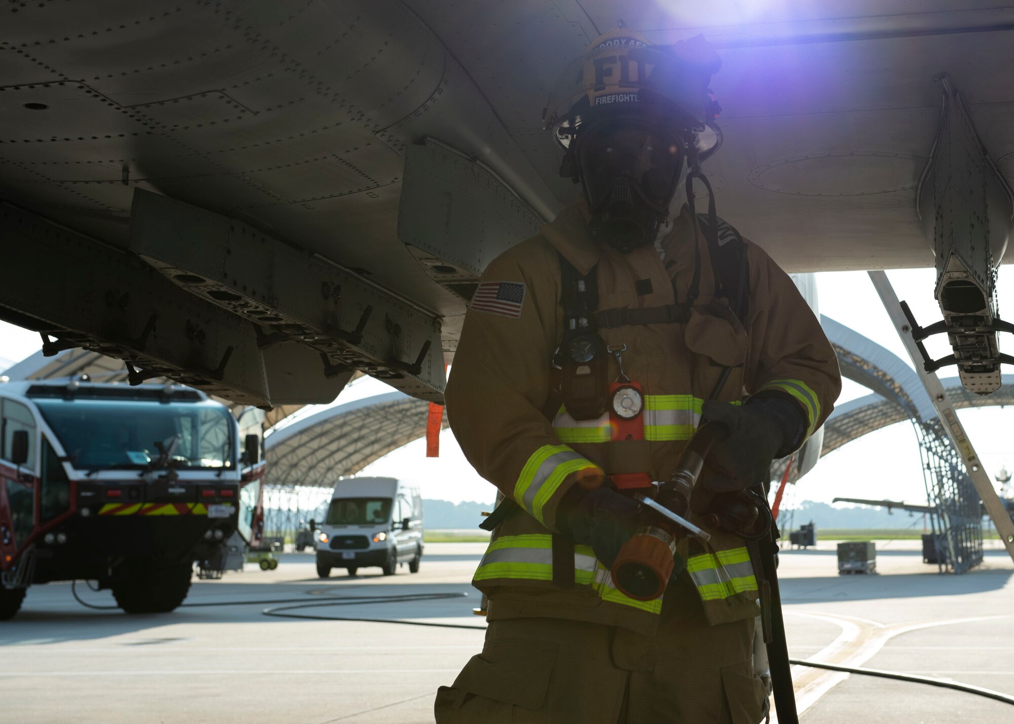Airman 1st Class Lakeem Coleman, 23d Civil Engineer Squadron (CES) firefighter, carries a hose during an A-10C Thunderbolt II egress training scenario, Aug. 9, 2019, at Moody Air Force Base, Ga. The 23d CES conducted the exercise to test their capability in extinguishing an A-10 on fire while simultaneously rescuing its pilot. The training also served as an opportunity for firefighter crew chiefs and their Airmen to increase team cohesion. (U.S. Air Force photo by Airman Azaria E. Foster)