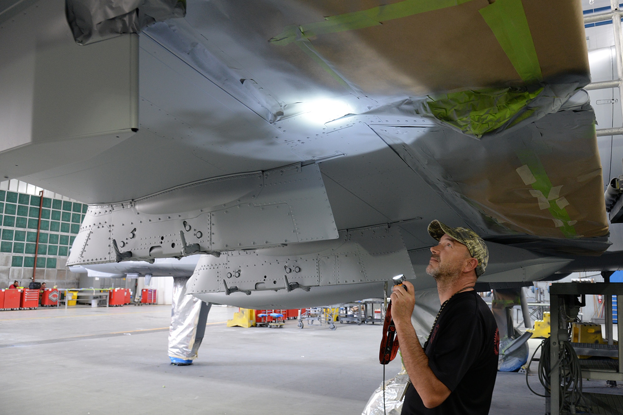 576th Aircraft Maintenance Squadron corrosion control painter Dale Benoit inspects newly applied paint on the underside of the new wing of an A-10 Thunderbolt II, tail no. 80-0252, at Hill Air Force Base, Utah, July 3, 2019. The aircraft was the last of 173 A-10s to receive new wings under the Enhanced Wing Assembly program to extend the flying service life of the fleet.  (U.S. Air Force photo by Alex R. Lloyd)