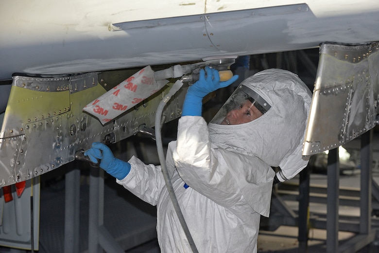 576th Aircraft Maintenance Squadron corrosion control painter Kimberly Hight sands down the underside of the new wing on A-10 Thunderbolt II, tail no. 80-0252, at Hill Air Force Base, Utah, June 28, 2019. The aircraft was the last of 173 A-10s to receive new wings under the Enhanced Wing Assembly program to extend the flying service life of the fleet.  (U.S. Air Force photo by Alex R. Lloyd)