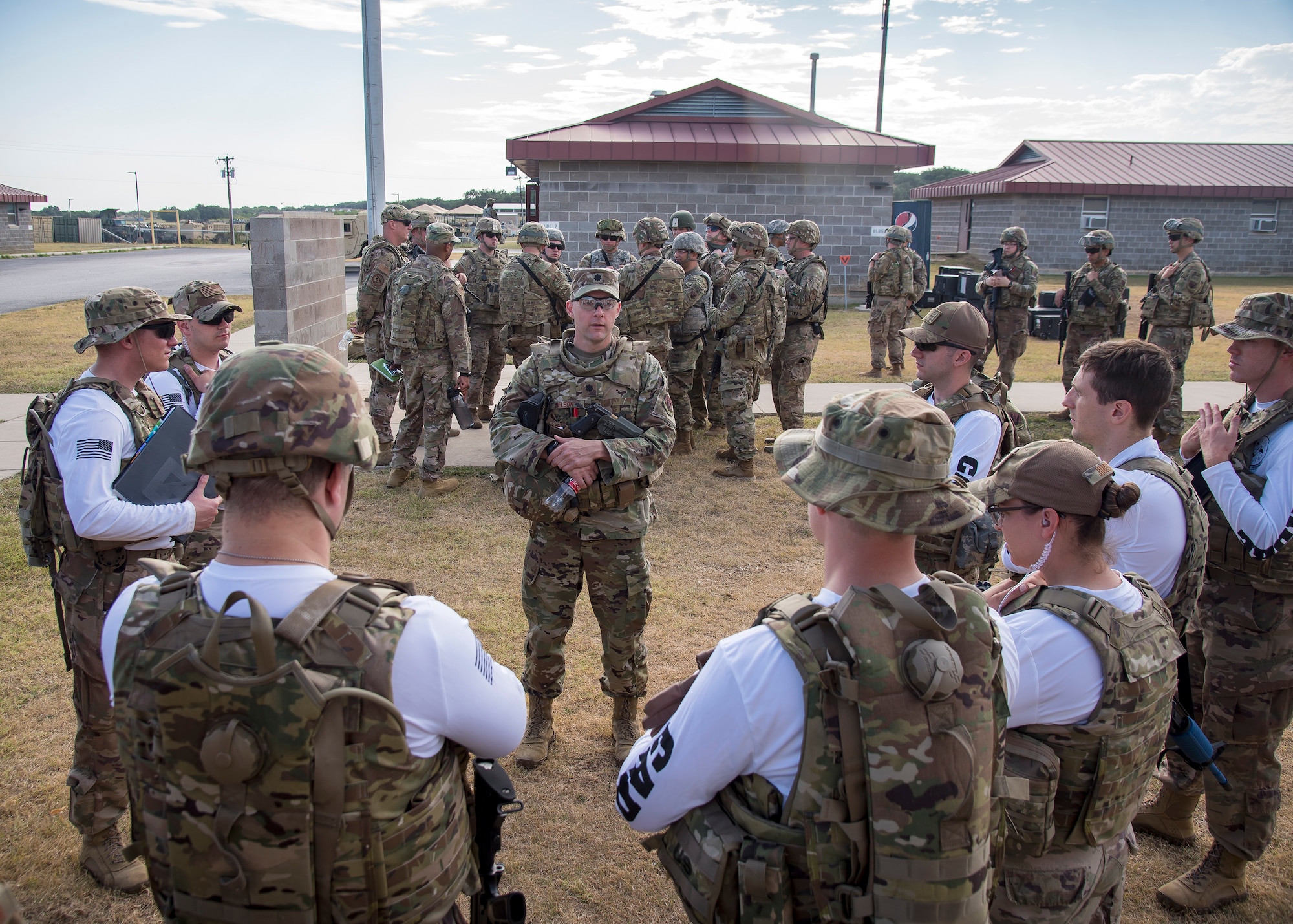Lt. Col. Robert Nelson, center, 3d Weather Squadron commander, briefs evaluators during a certification field exercise (CFX), July 29, 2019, at Camp Bowie Training Center, Texas. The CFX was designed to evaluate the squadron’s overall tactical ability and readiness to provide the U.S. Army with full spectrum environmental support to the Joint Task Force (JTF) fight. While deployed, the Army relies on the 3d WS to provide them with current ground weather reports. These reports are then employed by commanders on the ground as they plan the best tactics and approaches to accomplish the mission. (U.S. Air Force photo by Airman 1st Class Eugene Oliver)