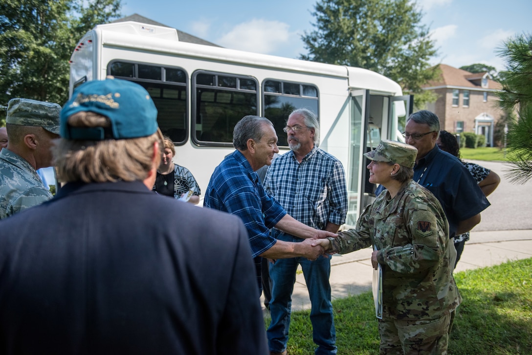 Chief Samuel Bass, Nansemond Indian Nation, gifts a coin of appreciation to U.S. Air Force Col. Erin Cluff, 633rd Mission Support Group commander, during a Native American tribal Consultation Visit at Joint Base Langley-Eustis, Virginia, Aug. 8, 2019.