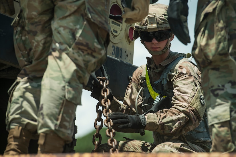 U.S. Army Spc. Lexie West, a wheeled vehicle mechanic assigned to the 659th Support Maintenance Company, 264th Combat Sustainment Support Battalion from Fort Bragg, N.C., secures a military vehicle onto a rail system during Exercise Dragon Lifeline Aug. 7, 2019, at Joint Base Charleston’s Naval Weapons Station, S.C. The deployment readiness exercise combined the capabilities of service members from Fort Bragg, N.C., Joint Base Charleston, S.C., and Joint Base Langley-Eustis, Va., and focused on the rapid deployment of equipment, vehicles and personnel. Participants shared knowledge and tested their efficiency in moving assets by air, land, rail and sea during the training event. The annual exercise is just one of the critical readiness exercises the DOD conducts to maintain a lethal and ready force. (U.S. Air Force photo by Tech. Sgt. Christopher Hubenthal)