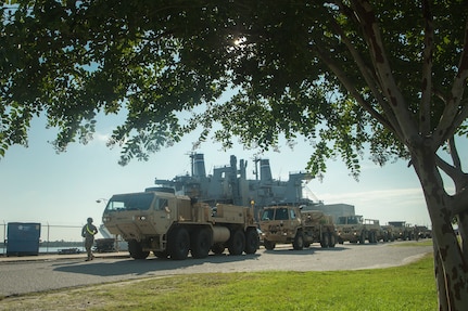 U.S. Army vehicles are staged prior to being moved onto the Logistics Naval Vessel Cape Decision during Exercise Dragon Lifeline Aug. 7, 2019, at the Federal Law Enforcement Training Center in Charleston, S.C. The exercise provided military personnel with experience needed to support rapid deployment operations across air, land, rail and sea. JB Charleston helps to provide rapid global deployment of personnel and equipment to deployed locations across the globe. The annual exercise is just one of the critical readiness exercises the DOD conducts to maintain a lethal and ready force. (U.S. Air Force photo by Tech. Sgt. Christopher Hubenthal)