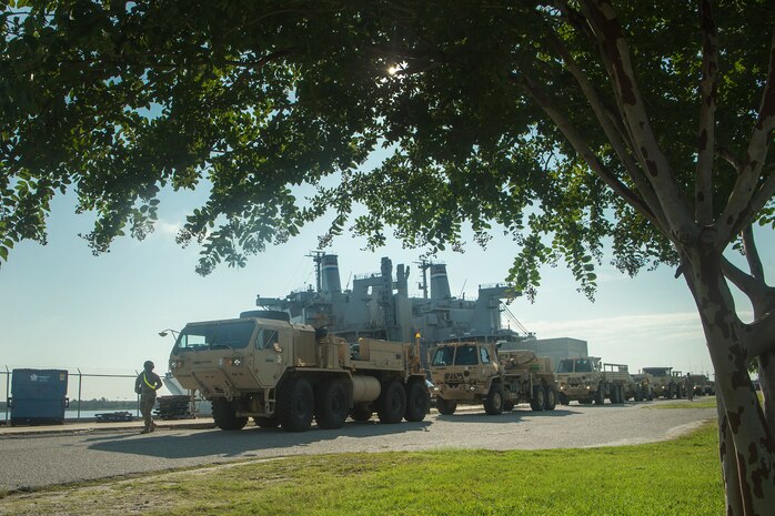 U.S. Army vehicles are staged prior to being moved onto the Logistics Naval Vessel Cape Decision during Exercise Dragon Lifeline Aug. 7, 2019, at the Federal Law Enforcement Training Center in Charleston, S.C. The exercise provided military personnel with experience needed to support rapid deployment operations across air, land, rail and sea. JB Charleston helps to provide rapid global deployment of personnel and equipment to deployed locations across the globe. The annual exercise is just one of the critical readiness exercises the DOD conducts to maintain a lethal and ready force. (U.S. Air Force photo by Tech. Sgt. Christopher Hubenthal)