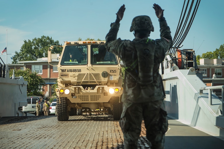 U.S. Army Staff Sgt. Conrad Stewart, a motor transport operator assigned to the 18th Field Artillery Brigade, 188th Brigade Support Battalion from Fort Bragg, N.C., directs army vehicles onto Logistics Naval Vessel Cape Decision during Exercise Dragon Lifeline Aug. 7, 2019, at the Federal Law enforcement Training Center in Charleston, S.C. The deployment readiness exercise combined the capabilities of service members from Fort Bragg, N.C., Joint Base Charleston, S.C., and Joint Base Langley-Eustis, Va., focused on the rapid deployment of equipment, vehicles and personnel. Participants shared knowledge and tested their efficiency in moving assets by air, land, rail and sea during the training event. The annual exercise is just one of the critical readiness exercises the DOD conducts to maintain a lethal and ready force. (U.S. Air Force photo by Tech. Sgt. Christopher Hubenthal)