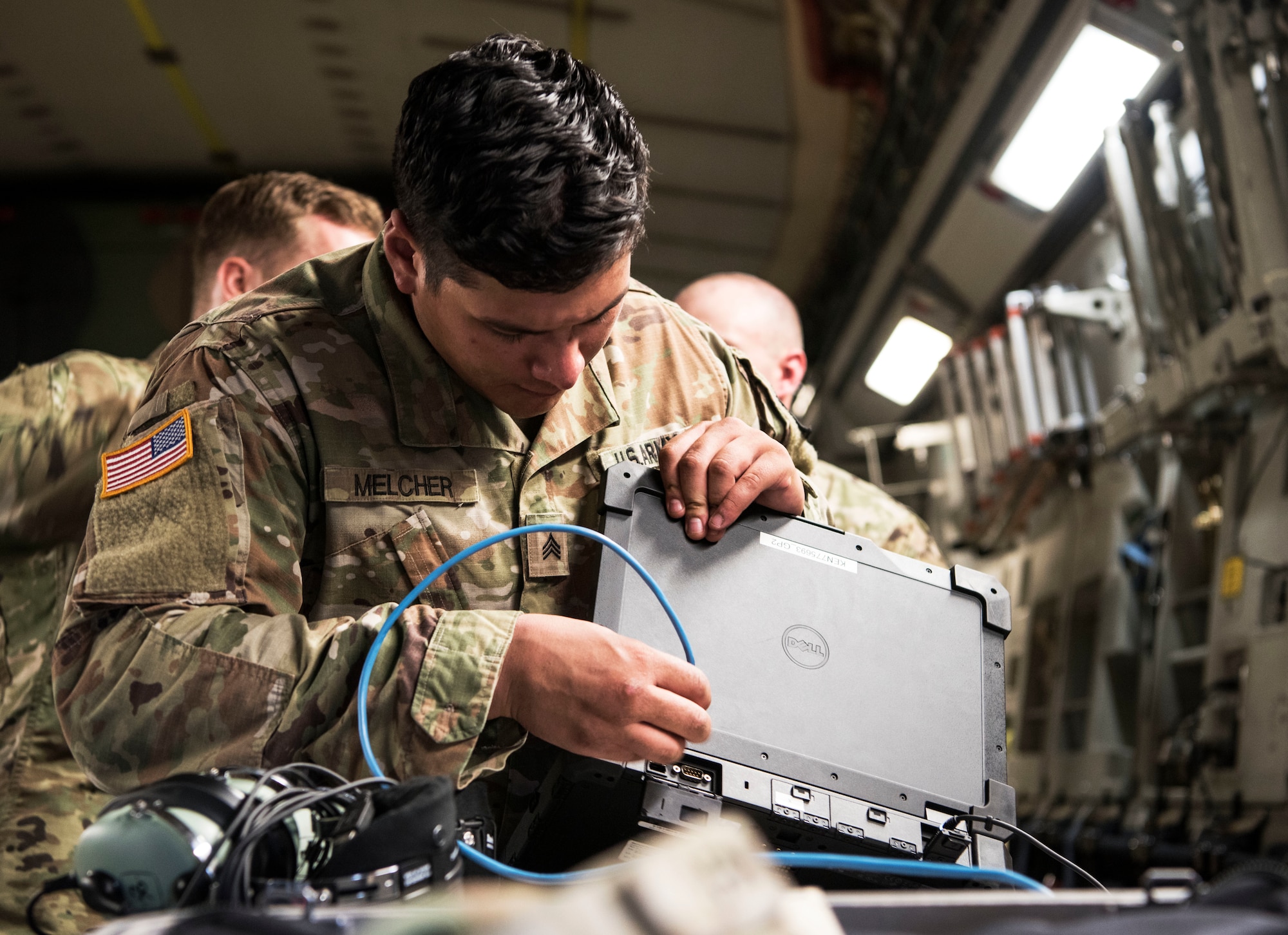 U.S. Army Sgt. Brandon Melcher, a ken operator team chief assigned to the 50th Expeditionary Signal Battalion Enhanced, prepares equipment prior to conducting aerial operations as part of Exercise Dragon Lifeline August 8, 2019, at Joint Base Charleston, S.C. The exercise provided military personnel with experience needed to support rapid deployment operations across air, land, rail and sea. JB Charleston helps to provide rapid global deployment of personnel and equipment to deployed locations across the globe. The annual exercise is just one of the critical readiness exercises the DOD conducts to maintain a lethal and ready force. (U.S. Air Force photo by Staff Sgt. Tenley Long)