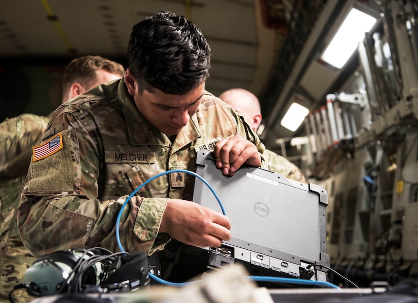 U.S. Army Sgt. Brandon Melcher, a ken operator team chief assigned to the 50th Expeditionary Signal Battalion Enhanced, prepares equipment prior to conducting aerial operations as part of Exercise Dragon Lifeline August 8, 2019, at Joint Base Charleston, S.C. The exercise provided military personnel with experience needed to support rapid deployment operations across air, land, rail and sea. JB Charleston helps to provide rapid global deployment of personnel and equipment to deployed locations across the globe. The annual exercise is just one of the critical readiness exercises the DOD conducts to maintain a lethal and ready force. (U.S. Air Force photo by Staff Sgt. Tenley Long)