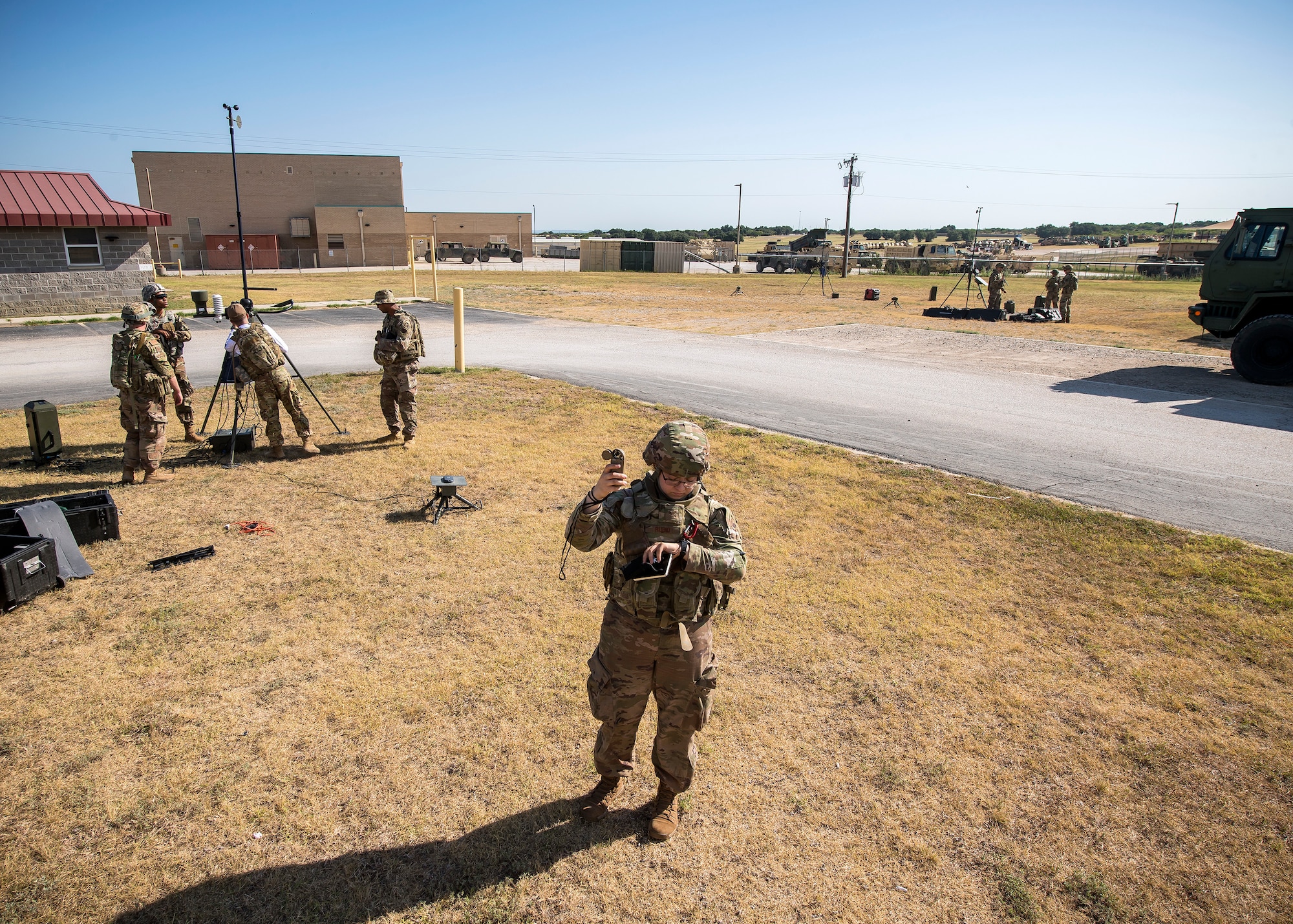 Senior Airman Mary-Morgan Rubio, front, 3d Weather Squadron (WS) Det 2 weather forecaster, reads a kestrel meter during a certification field exercise (CFX), July 29, 2019, at Camp Bowie Training Center, Texas. The CFX was designed to evaluate the squadron’s overall tactical ability and readiness to provide the U.S. Army with full spectrum environmental support to the Joint Task Force (JTF) fight. While deployed, the Army relies on the 3d WS to provide them with current ground weather reports. These reports are then employed by commanders on the ground as they plan the best tactics and approaches to accomplish the mission. (U.S. Air Force photo by Airman 1st Class Eugene Oliver)