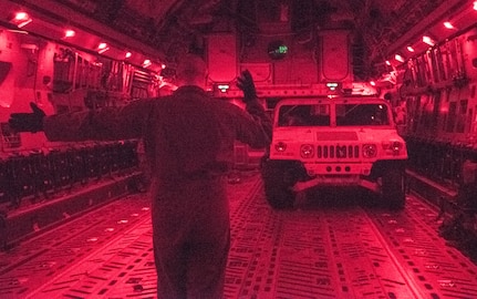 U.S. Air Force Tech Sgt. Scott Stueven, a load master assigned to the 437th Operations Group, marshals a Humvee off the ramp of a C-17 Globemaster III during Exercise Dragon Lifeline August 8, 2019, at Fort Bragg, N.C. The exercise provided military personnel with experience needed to support rapid deployment operations across air, land, rail and sea. JB Charleston helps to provide rapid global deployment of personnel and equipment to deployed locations across the globe. The annual exercise is just one of the critical readiness exercises the DOD conducts to maintain a lethal and ready force. (U.S. Air Force photo by Staff Sgt. Tenley Long)