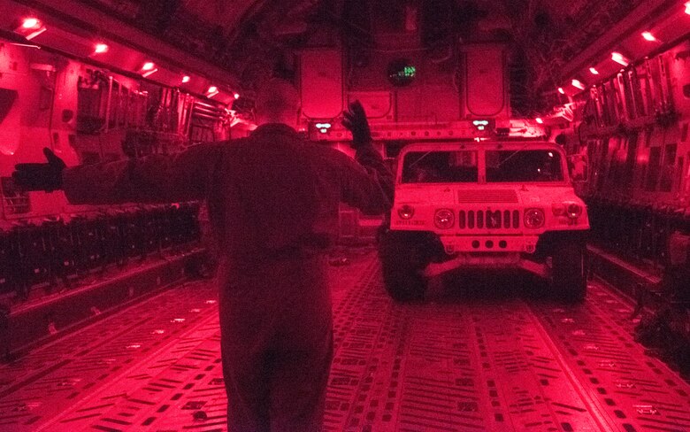 U.S. Air Force Tech Sgt. Scott Stueven, a load master assigned to the 437th Operations Group, marshals a Humvee off the ramp of a C-17 Globemaster III during Exercise Dragon Lifeline August 8, 2019, at Fort Bragg, N.C. The exercise provided military personnel with experience needed to support rapid deployment operations across air, land, rail and sea. JB Charleston helps to provide rapid global deployment of personnel and equipment to deployed locations across the globe. The annual exercise is just one of the critical readiness exercises the DOD conducts to maintain a lethal and ready force. (U.S. Air Force photo by Staff Sgt. Tenley Long)