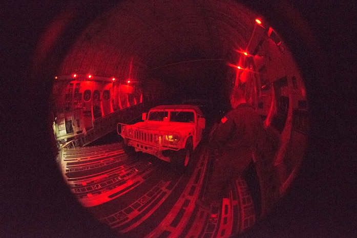 U.S. Air Force Tech Sgt. Scott Stueven, a load master assigned to the 437th Operations Group, marshals a Humvee off the ramp of a C-17 Globemaster III during Exercise Dragon Lifeline August 8, 2019, at Fort Bragg, N.C. The deployment readiness exercise combined the capabilities of service members from Fort Bragg, N.C., Joint Base Charleston, S.C., and Joint Base Langley-Eustis, Va., and focused on the rapid deployment of equipment, vehicles and personnel. Participants shared knowledge and tested their efficiency in moving assets by air, land, rail and sea during the training event. The annual exercise is just one of the critical readiness exercises the DOD conducts to maintain a lethal and ready force. (U.S. Air Force photo by Staff Sgt. Tenley Long)
