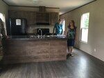 Amy Dixon takes a tour of her new mobile home unit that was turned over Aug. 9, 2019, upon completion through the RISE West Virginia program.