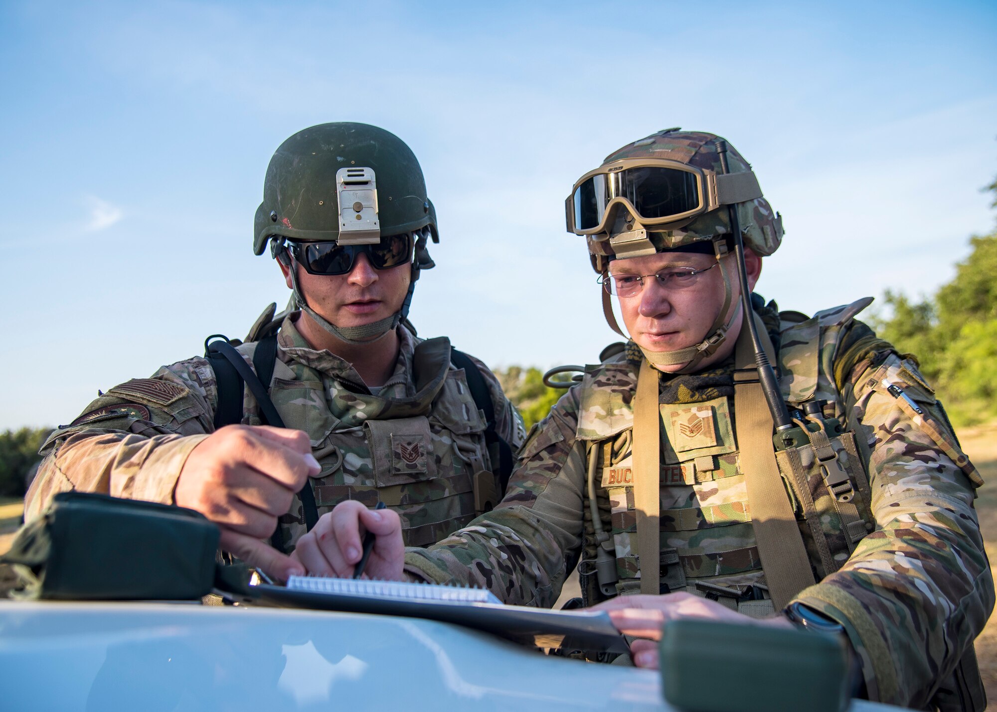 Staff Sgt. Austin Buckhalter, right, 3d Weather Squadron weather forecaster, and Tech Sgt. Nicolas Graham, 3 WS Det 2 NCO in charge of Brigade Combat Team weather operations, plot out coordinates during a certification field exercise (CFX), July 31, 2019, at Camp Bowie Training Center, Texas. The CFX was designed to evaluate the squadron’s overall tactical ability and readiness to provide the U.S. Army with full spectrum environmental support to the Joint Task Force (JTF) fight. The CFX immersed Airmen into all the aspects of what could come with a deployment such as Land Navigation. (U.S. Air Force photo by Airman 1st Class Eugene Oliver)