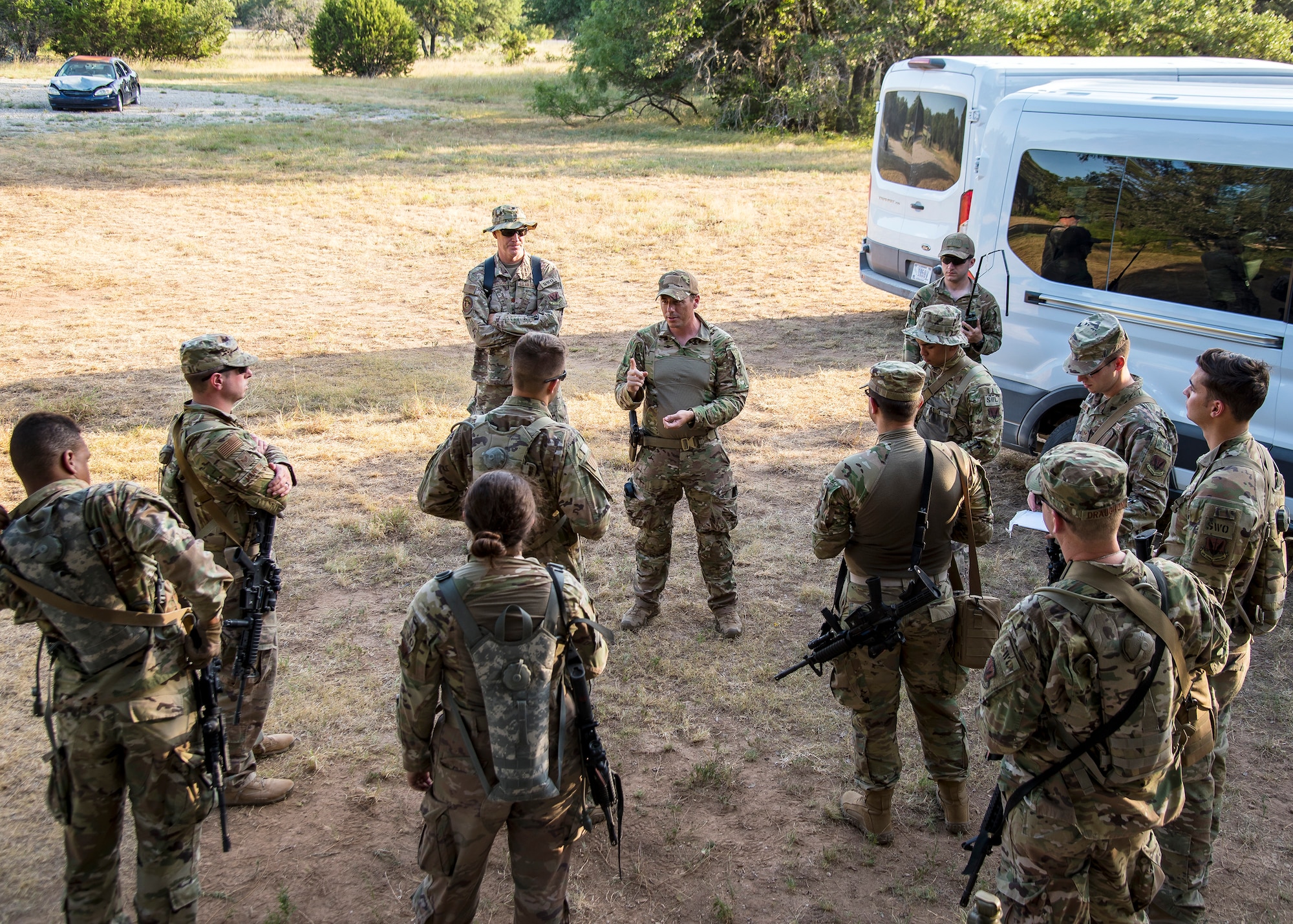 Master Sgt. Charles Kuykendall, center, 3d Weather Squadron operations superintendent, gives instruction during a certification field exercise (CFX), July 31, 2019, at Camp Bowie Training Center, Texas. The CFX was designed to evaluate the squadron’s overall tactical ability and readiness to provide the U.S. Army with full spectrum environmental support to the Joint Task Force (JTF) fight. The CFX immersed Airmen into all the aspects of what could come with a deployment such as Land Navigation. (U.S. Air Force photo by Airman 1st Class Eugene Oliver)