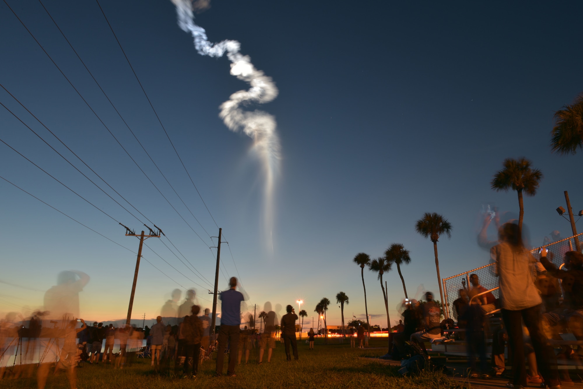 Dozens of people observe an Atlas V rocket Aug. 8, 2019, as it carries the Fifth Advanced Extremely High Frequency satellite toward space after it was launched from Cape Canaveral Air Force Station, Florida. In April, Airmen assigned to Travis Air Force Base, California, transported the satellite to Florida. The satellite will provide enhanced communications for high-priority military assets. (U.S. Air Force photo by Airman 1st Class Dalton Williams)