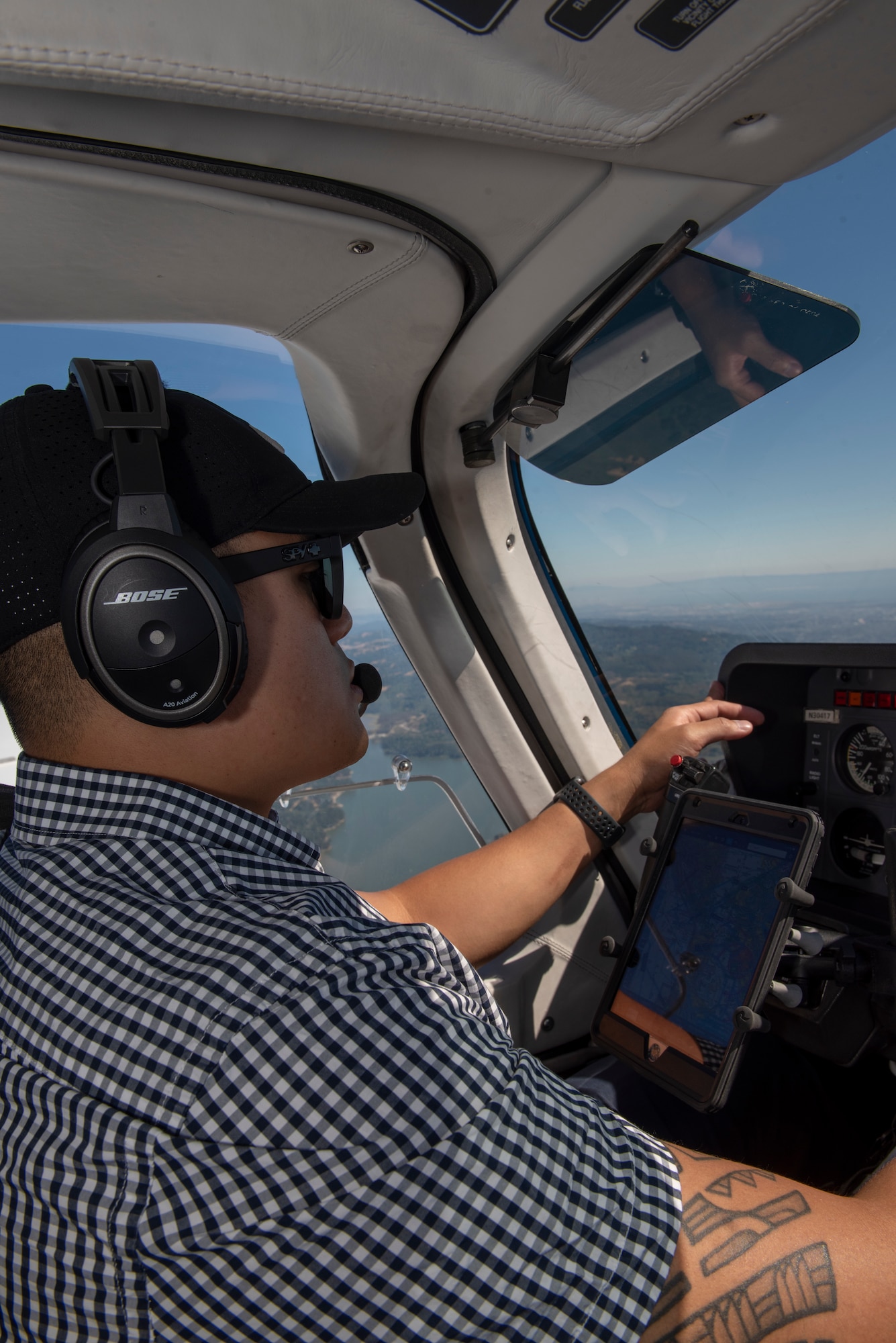 U.S. Air Force Tech. Sgt. Ron, 860th Aircraft Maintenance Squadron flight line expediter, mans the controls of a Socata Trinidad TB-20 July 27, 2019, during a flight over the San Francisco Bay Area. Ron has accumulated more than 250 flying hours and completed Air Force remote pilot aircraft training July 12. (U.S. Air Force photo by Tech. Sgt. James Hodgman)