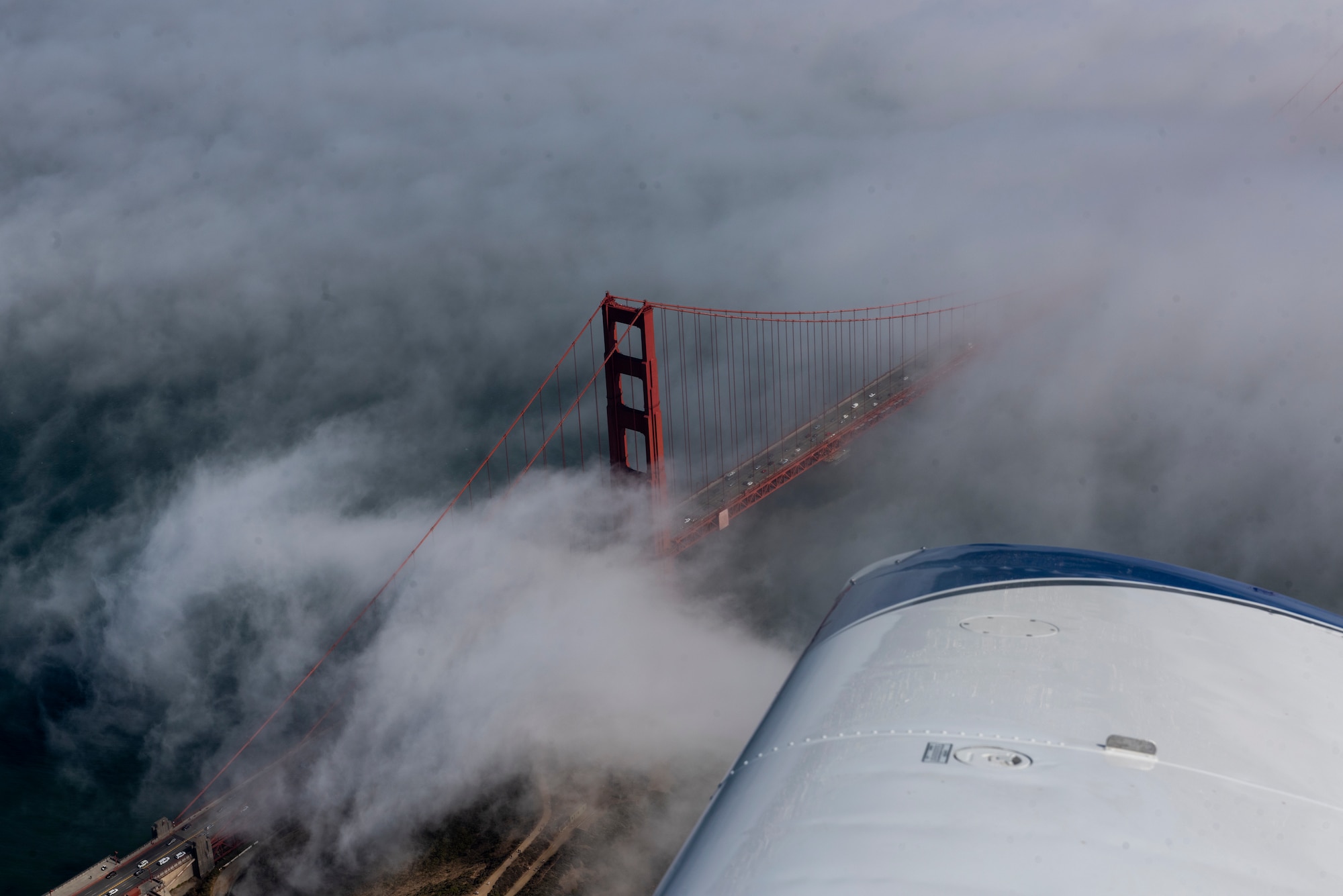 The Golden Gate Bridge is visible from a Socata Trinidad TB-20 aircraft July 27, 2019, during a flight over the San Francisco Bay Area. The plane was piloted by U.S. Air Force Tech. Sgt. Ron, 860th Aircraft Maintenance Squadron flight line expediter. Ron has accumulated more than 250 flying hours and completed Air Force remote pilot aircraft training July 12. (U.S. Air Force photo by Tech. Sgt. James Hodgman)