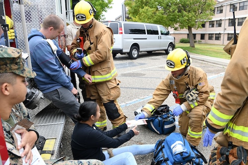 Staff Sgt. Cinthia Swartzlander, 30th Civil Engineering Squadron, assists a simulated victim during an active shooter exercise Aug. 7, 2019, at Vandenberg Air Force Base, Calif.