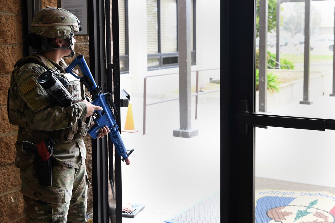 Staff Sgt. Cinthia Swartzlander, 30th Security Forces Squadron patrolman, guards an exit during an active shooter exercise Aug. 7, 2019, at Vandenberg Air Force Base, Calif.