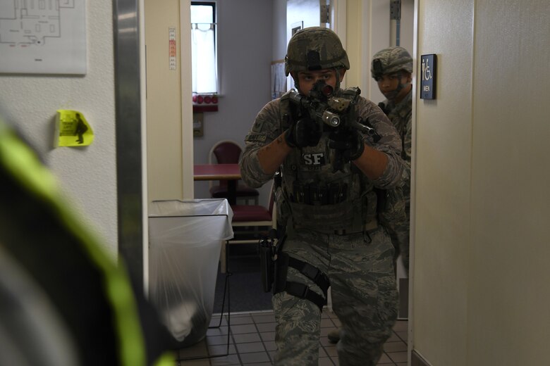 Staff Sgt. Cody Kraft and Senior Airman Isaiah Aguilar, 30th Security Forces Squadron patrolmen, sweep a building during an active shooter exercise Aug. 7, 2019, at Vandenberg Air Force Base, Calif.