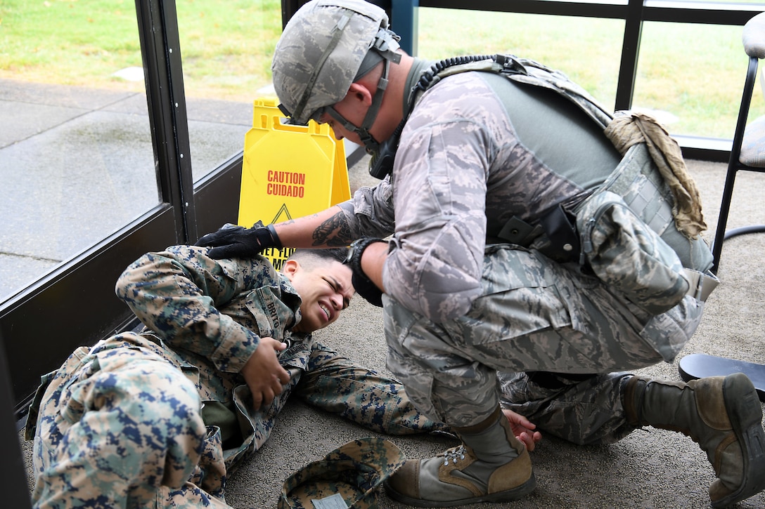 Staff Sgt. Cody Kraft, 30th Security Forces Squadron patrolman, assists a victim during an active shooter exercise Aug. 7, 2019, at Vandenberg Air Force Base, Calif.