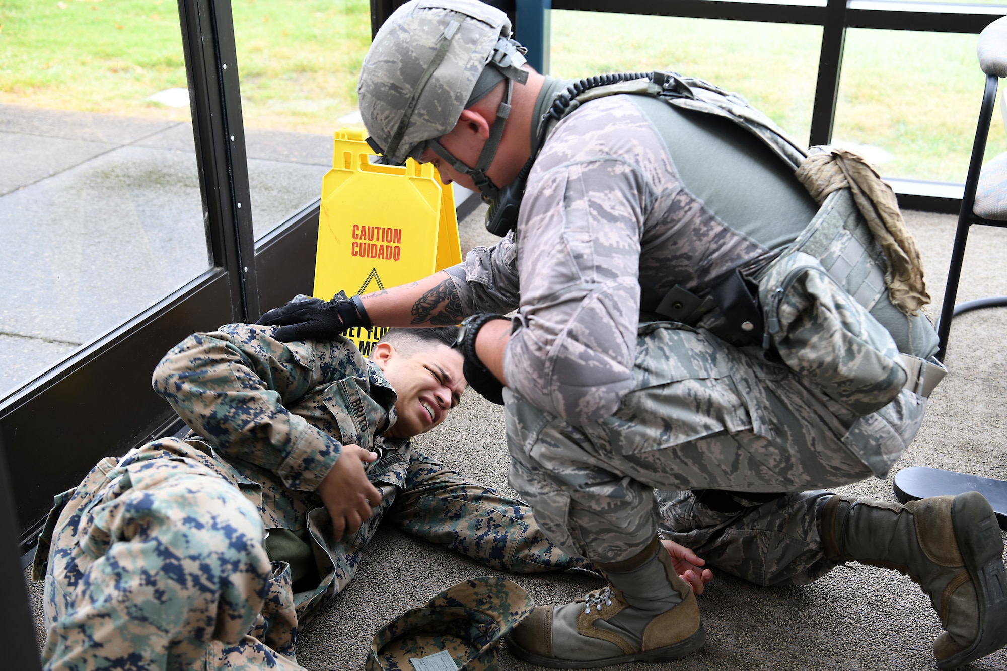 Staff Sgt. Cody Kraft, 30th Security Forces Squadron patrolman, assists a victim during an active shooter exercise Aug. 7, 2019, at Vandenberg Air Force Base, Calif.