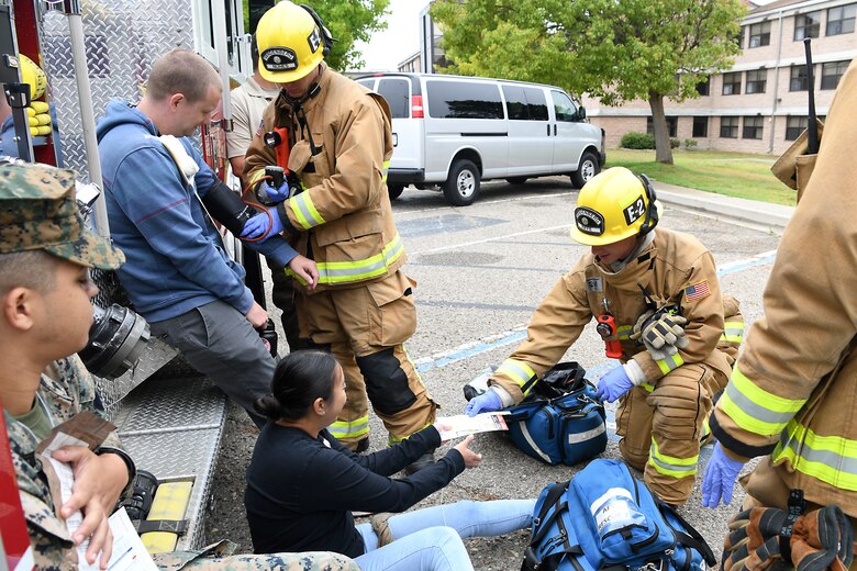 Staff Sgt. Cinthia Swartzlander, 30th Civil Engineering Squadron, assists a simulated victim during an active shooter exercise Aug. 7, 2019, at Vandenberg Air Force Base, Calif.
