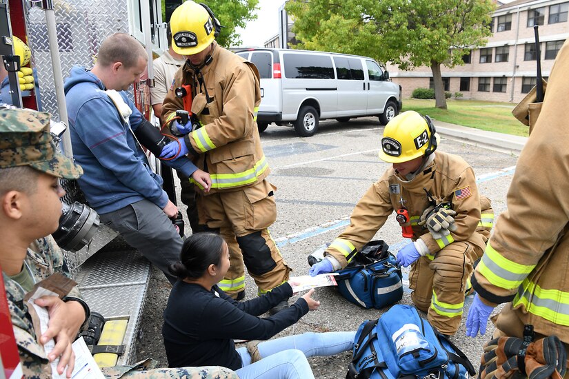Staff Sgt. Cinthia Swartzlander, 30th Civil Engineering Squadron, assists a simulated victim during an active shooter exercise Aug. 7, 2019, at Vandenberg Air Force Base, Calif.
