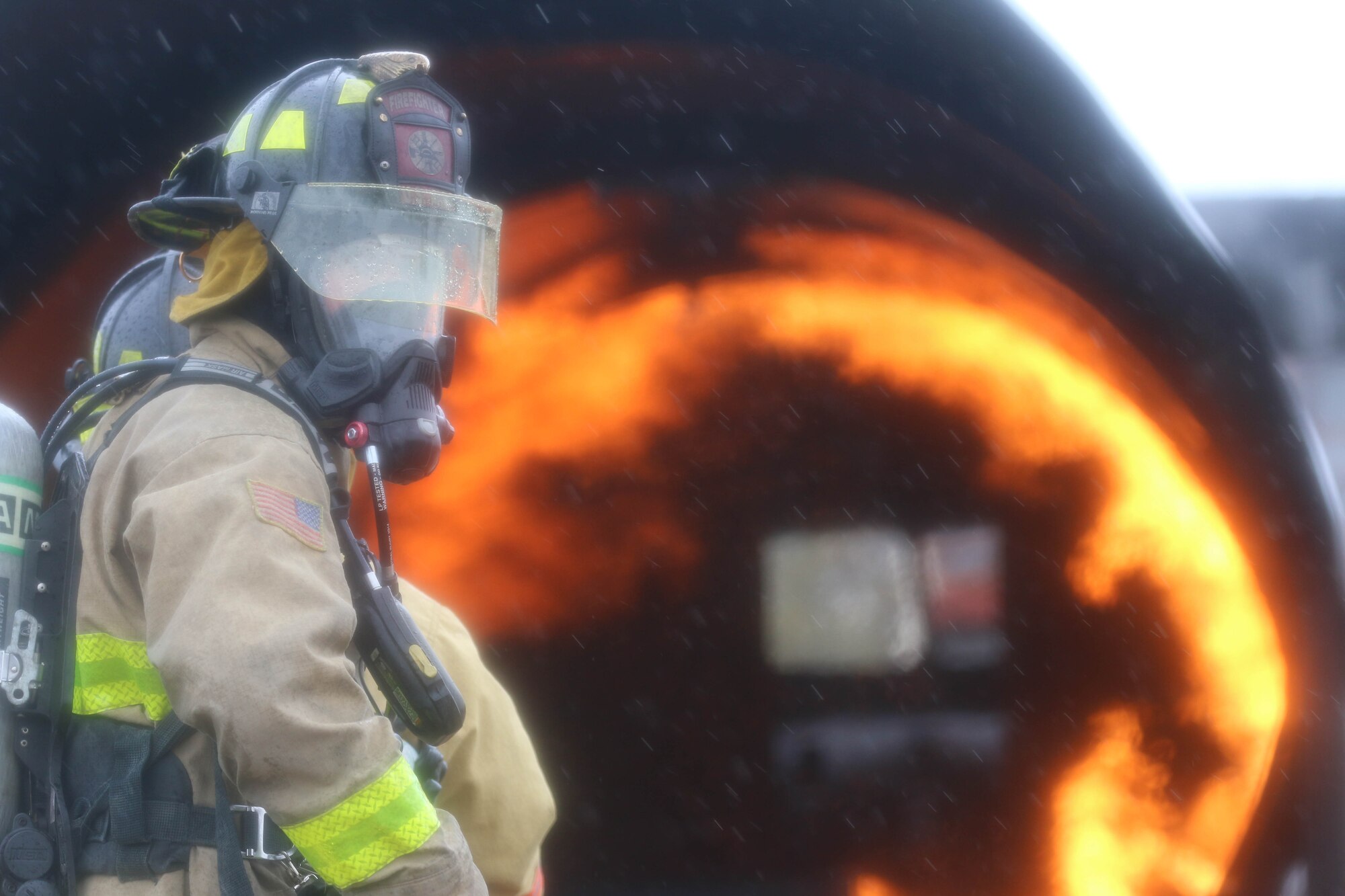 Firefighter prepares to extinguish blaze