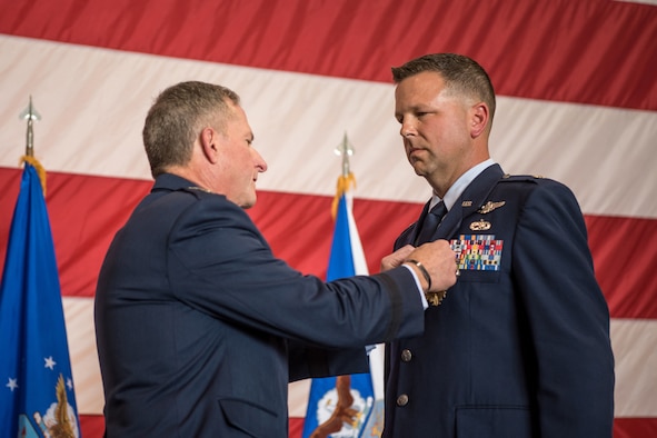 Lt. Col. John "J.T." Hourigan (right), a pilot for the 123rd Airlift Wing, is pinned with the Distinguished Flying Cross by Gen. David L. Goldfein, Air Force chief of staff, during a ceremony at the Kentucky Air National Guard Base in Louisville, Ky., Aug. 10, 2019. Hourigan earned the award for preventing a catastrophic, in-flight mishap that would have resulted in the loss of aircraft and crew if not for his decisive action. (U.S. Air National Guard photo by Staff Sgt. Joshua Horton)
