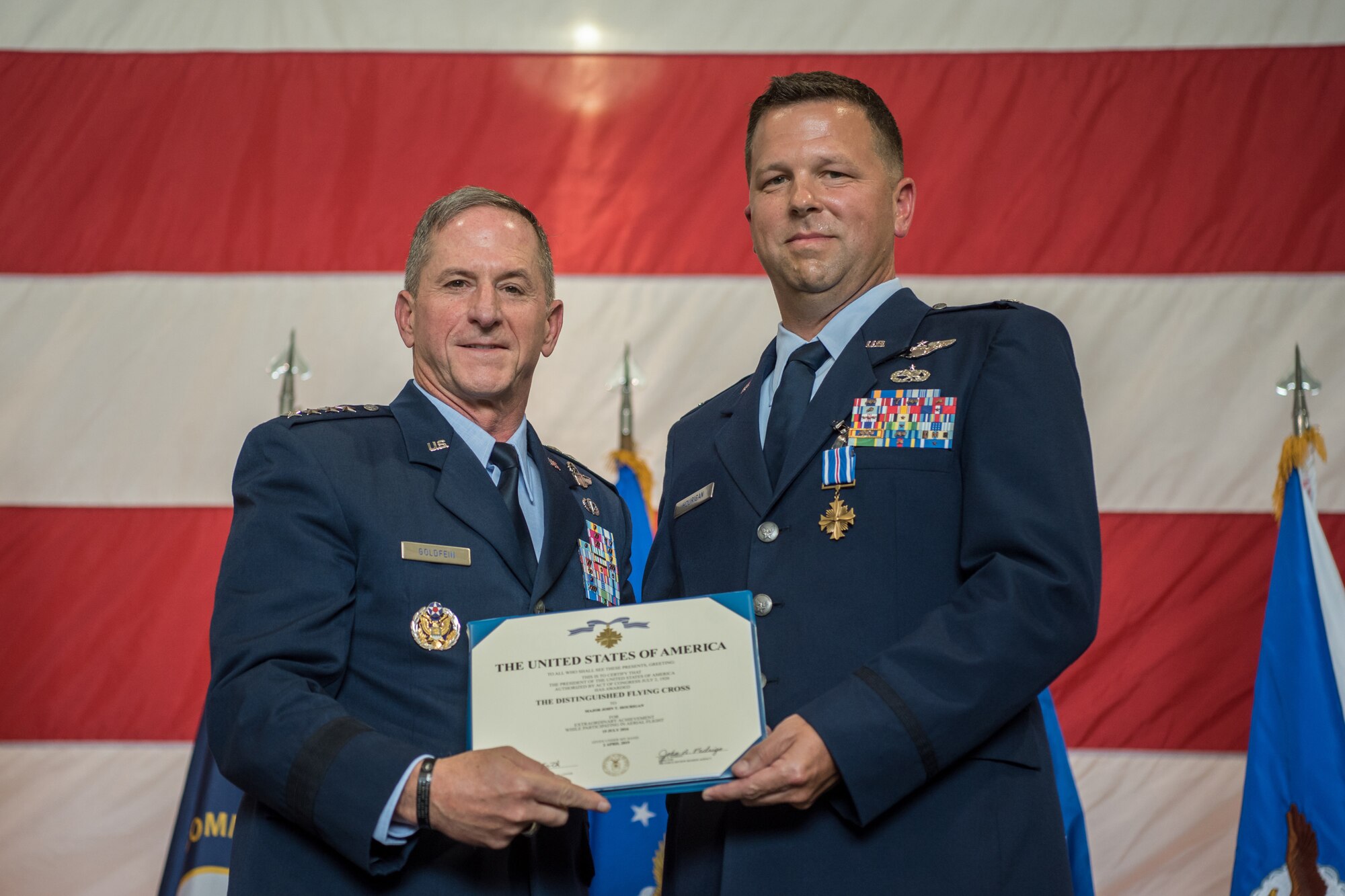 Lt. Col. John "J.T." Hourigan (right), a pilot for the 123rd Airlift Wing, receives the Distinguished Flying Cross from Gen. David L. Goldfein, Air Force chief of staff, during a ceremony at the Kentucky Air National Guard Base in Louisville, Ky., Aug. 10, 2019. Hourigan earned the award for preventing a catastrophic, in-flight mishap that would have resulted in the loss of aircraft and crew if not for his decisive action. (U.S. Air National Guard photo by Staff Sgt. Joshua Horton)
