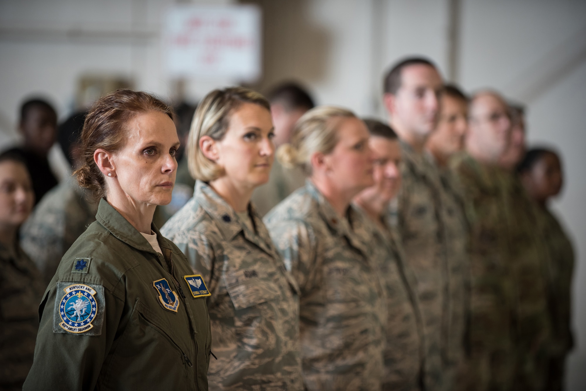 Members of the 123rd Airlift Wing attend a ceremony at the Kentucky Air National Guard Base in Louisville, Ky., Aug 10, 2019, during which the Air Force chief of staff, Gen. David L. Goldfein, presented the Distinguished Flying Cross to a Kentucky Air Guard pilot. The pilot, Lt. Col. John "J.T." Hourigan, earned the medal for decisive action following a catastrophic mechanical failure while flying a C-130 Hercules aircraft during a routine training sortie, saving the lives of six crew members and a $30 million aircraft. Flight Surgeon Lt. Col. Donna Stewart (far left) was one of those crew members. (U.S. Air National Guard photo by Lt. Col. Dale Greer)