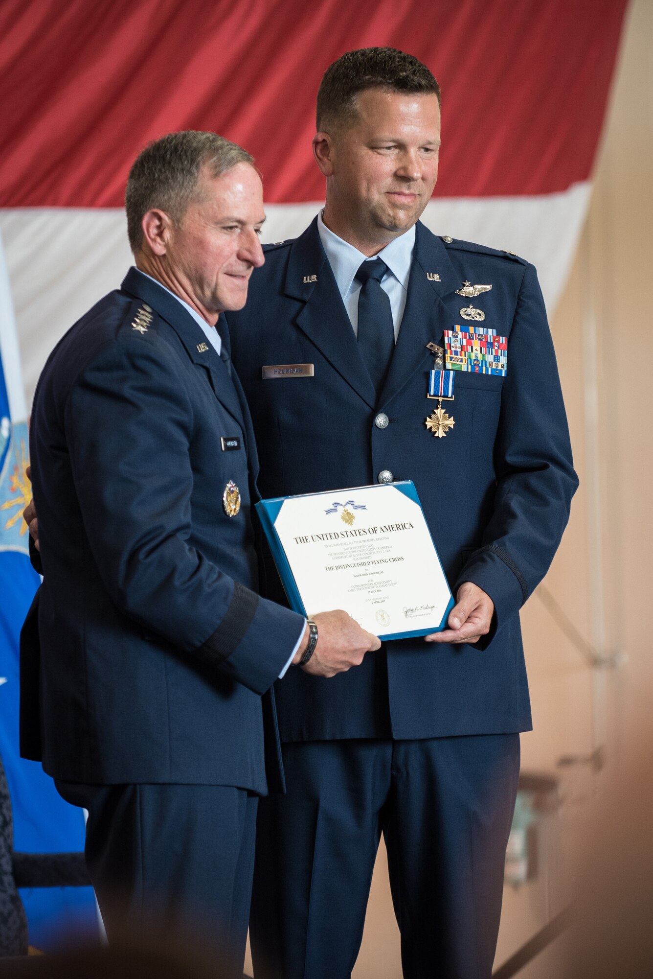 Air Force Chief of Staff Gen. David L. Goldfein (left) presents the Distinguished Flying Cross to Lt. Col. John "J.T." Hourigan, a pilot in the 123rd Airlift Wing, during a ceremony the Kentucky Air National Guard Base in Louisville, Ky., Aug. 10, 2019. Hourigan earned the medal for decisive action following a catastrophic mechanical failure while flying a C-130 Hercules during a routine training sortie, saving the lives of six crew members and a $30 million aircraft. (U.S. Air National Guard photo by Lt. Col. Dale Greer)