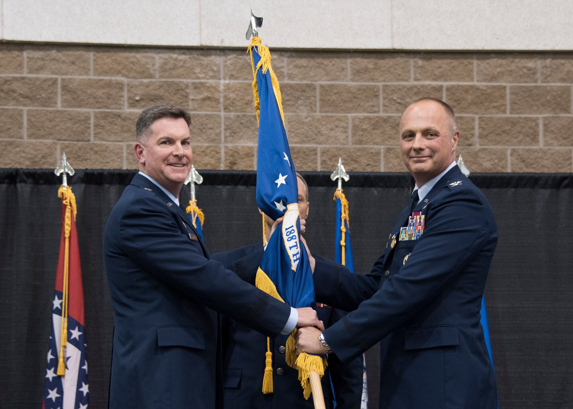Col. Robert I. Kenney relinquishes command of the 188th Wing to Brig. Gen. Thomas D. Crimmins, Arkansas National Guard air component commander, during a change of command ceremony at Fort Smith, Ark., Aug. 11, 2019. The change of command is a military tradition signified with the passing of the unit's guidon flag from one commander to the next. (U.S. Air National Guard photo by Tech. Sgt. John E. Hillier)