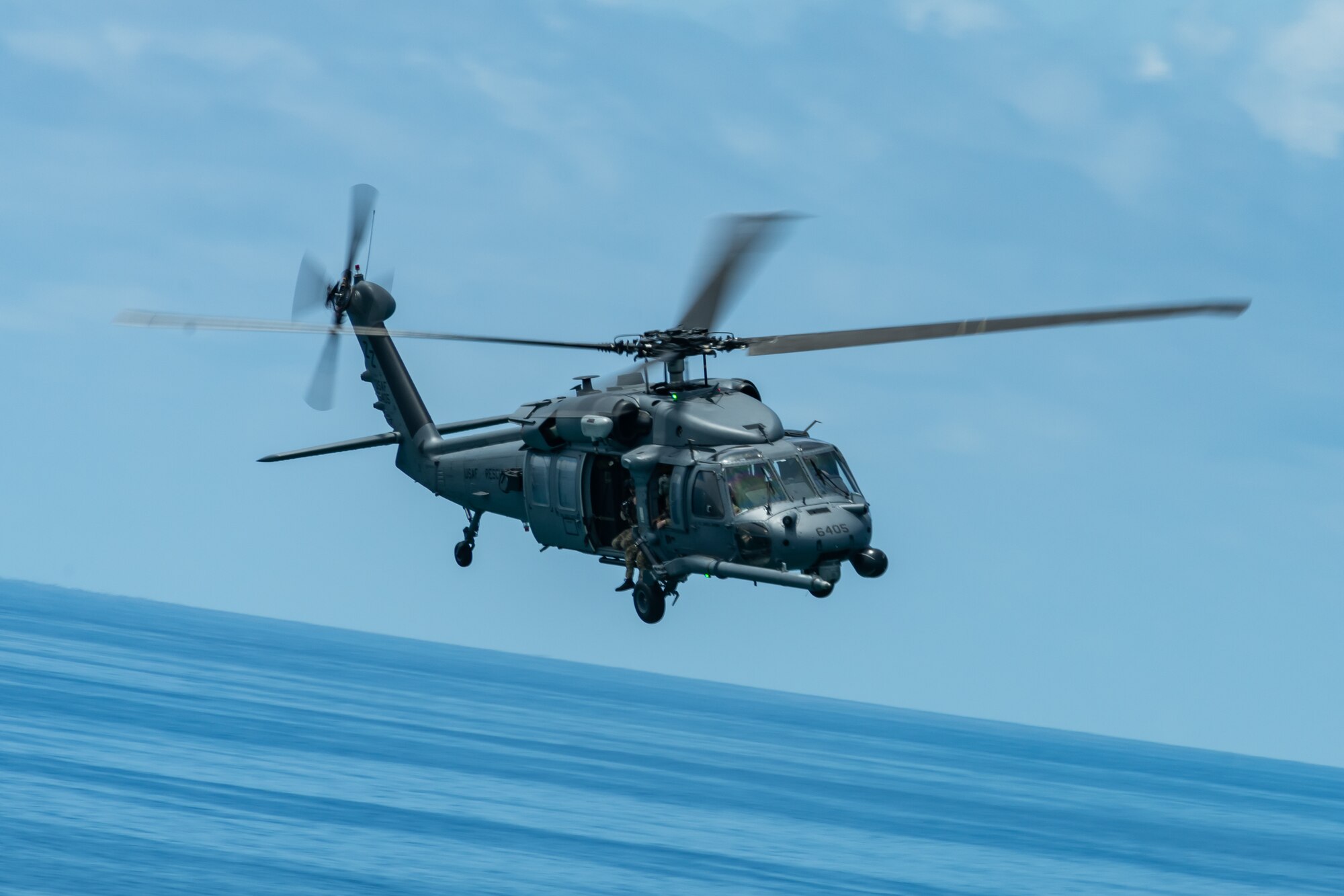 An HH-60G Pave Hawk from the 33rd Rescue Squadron flies during a training exercise, July 23, 2019, out of Kadena Air Base, Japan. The 33rd RQS has performed search, rescue, and recovery missions since 1952. (U.S. Air Force photo by Airman 1st Class Matthew Seefeldt)