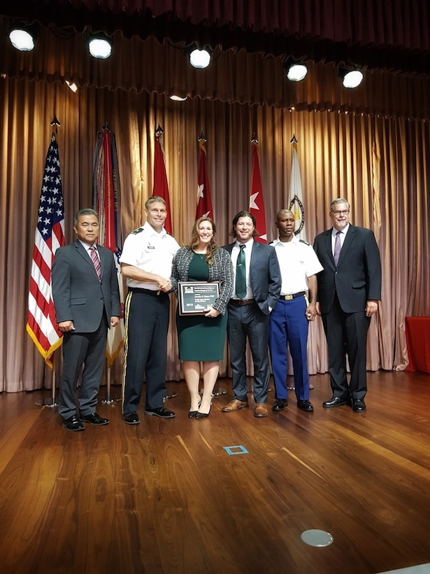 Jennifer Moore, U.S. Army Corps of Engineers (USACE), Far East District (FED), Air Force Program Branch Chief, stands with her husband Ross Moore, Security Operations Branch, physical security specialist, after being awarded the USACE Program Manager of the Year award, Washington, D.C., Aug. 2.
