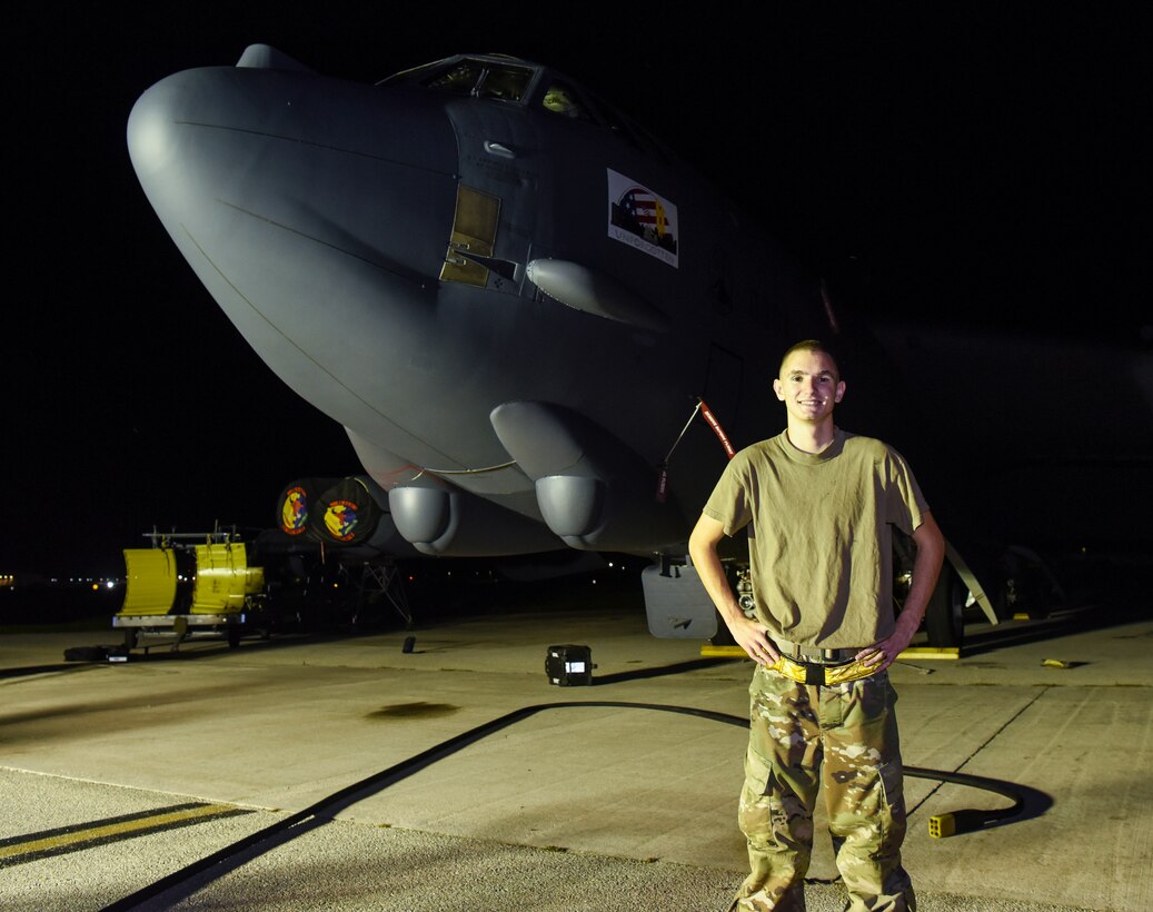 Senior Airman Dillain Lapolice, 36th Expeditionary Aircraft Maintenance Squadron aerospace propulsion journeyman, poses for a photo in front of a 69th Expeditionary Bomb Squadron B-52 Stratofortress on Andersen Air Force Base, Guam, Aug. 7, 2019.