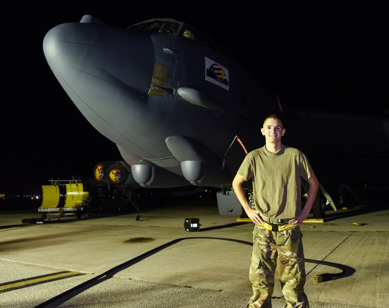 Senior Airman Dillain Lapolice, 36th Expeditionary Aircraft Maintenance Squadron aerospace propulsion journeyman, poses for a photo in front of a 69th Expeditionary Bomb Squadron B-52 Stratofortress on Andersen Air Force Base, Guam, Aug. 7, 2019.