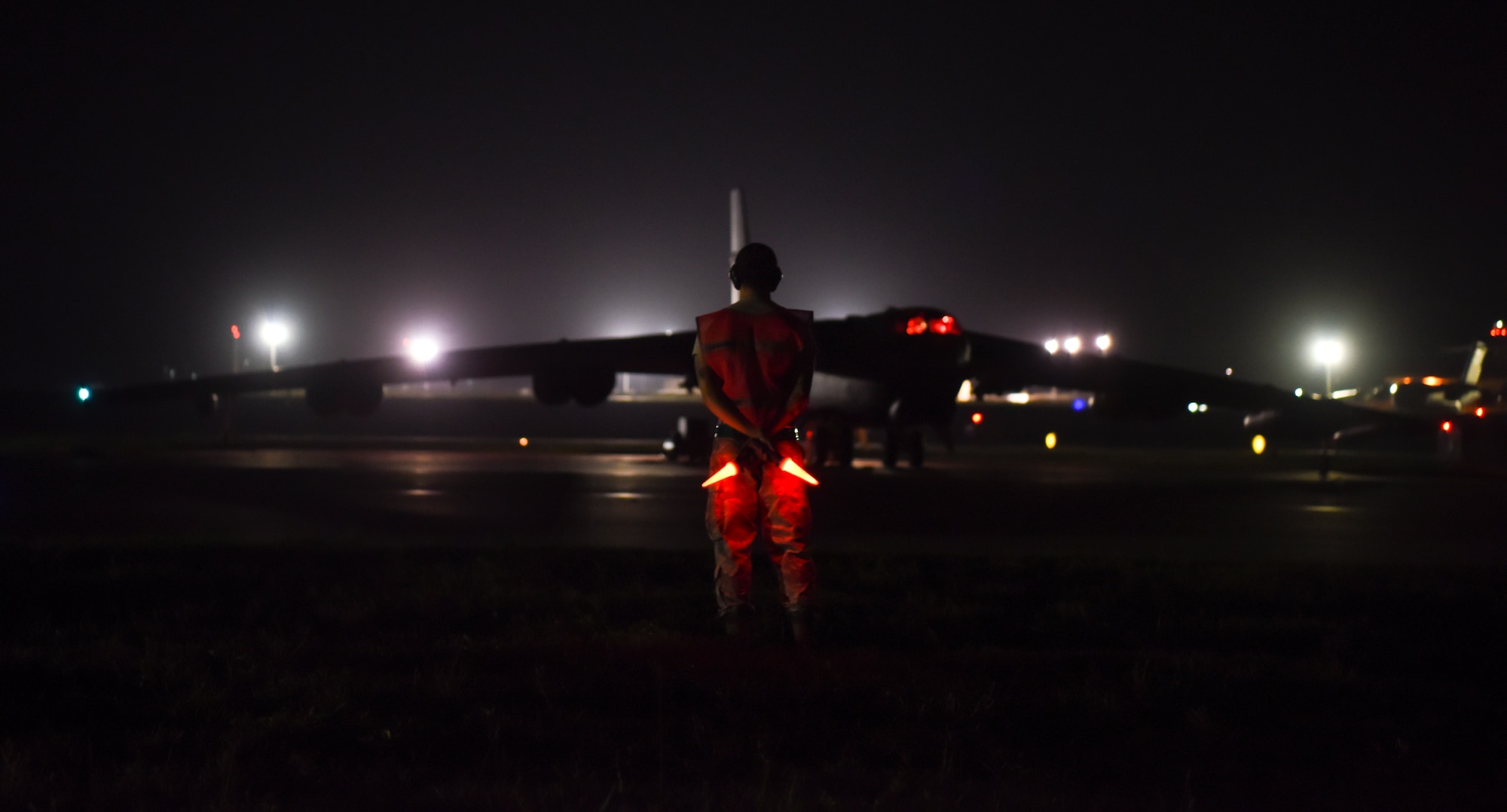Senior Airman Patrick Cervoni, 69th Aircraft Maintenance Squadron crew chief, prepares to marshal a 69th Expeditionary Bomb Squadron B-52 Stratofortress  on the flightline on Andersen Air Force Base, Guam, Aug. 7, 2019.